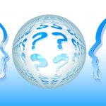two faces in profile either side of a globe full of question marks