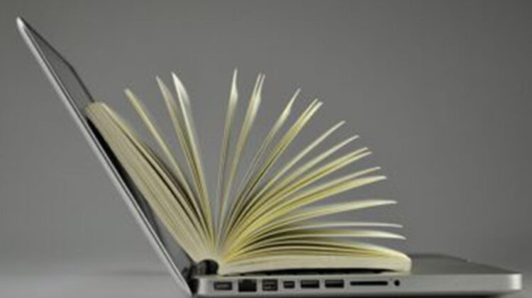 Laptop and pages of an open book