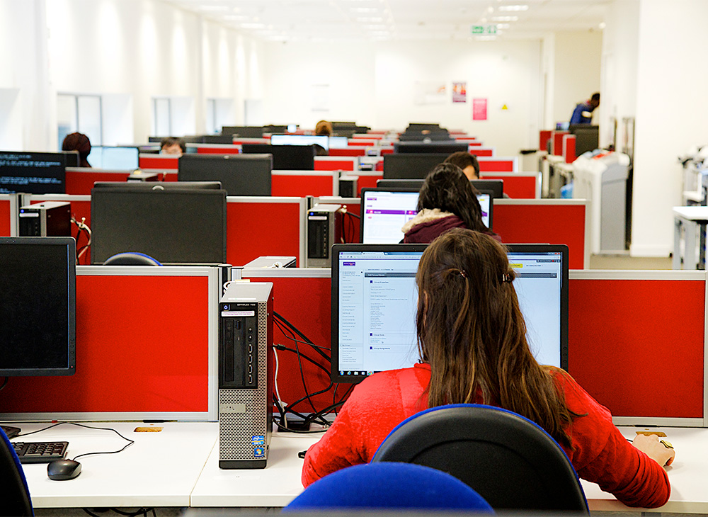 Image of students sat at computer workstations