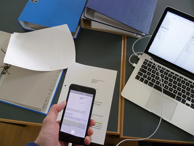 An image of a smartphone scanning a document.