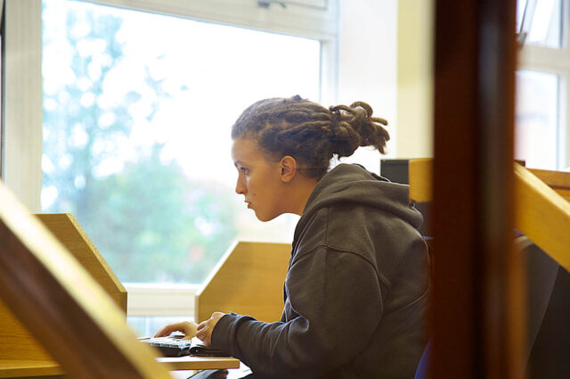 Student looking at screen with hand on keyboard
