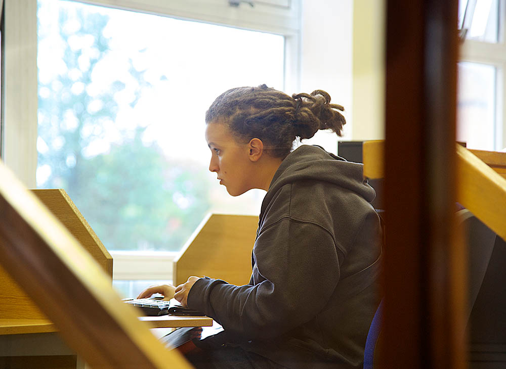 Student looking at screen with hand on keyboard