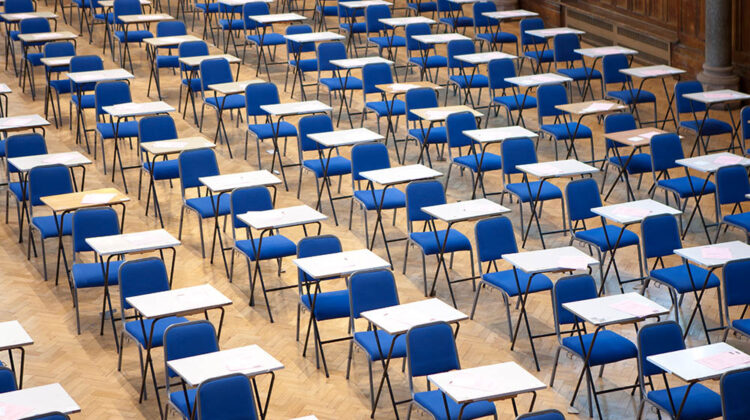 Picture of an empty room full of exam chairs and desks