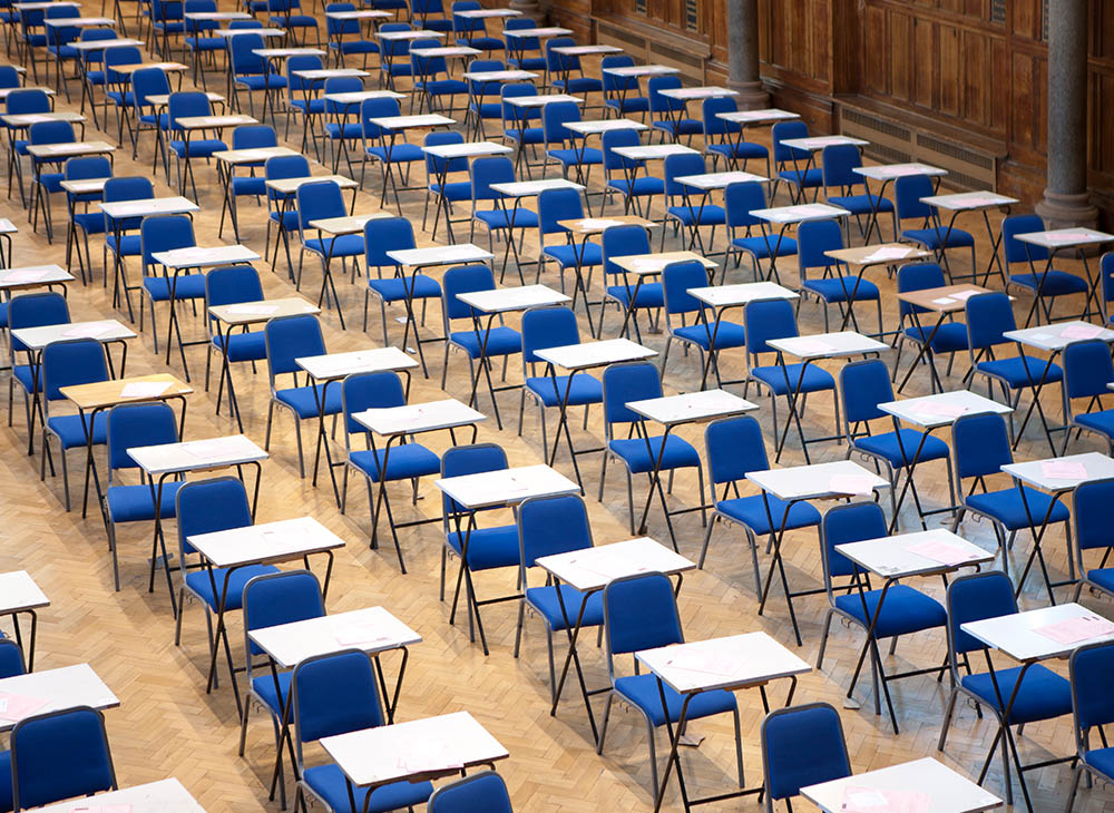 Picture of an empty room full of exam chairs and desks